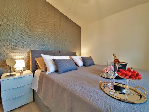 a bedroom with a bed with a tray of fruit on it at Holiday House Above with pool and summer kitchen in Klis