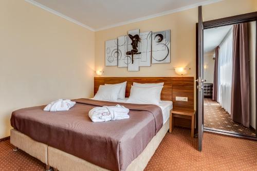 a hotel room with a bed with towels on it at Bratislava Hotel Kyiv in Kyiv