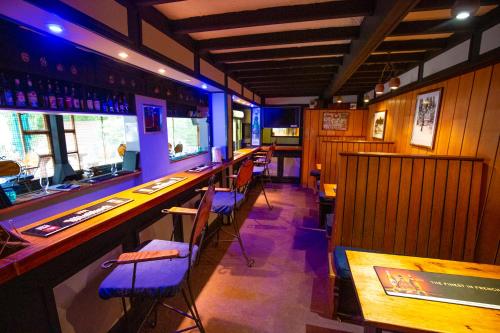 a bar in a restaurant with chairs and tables at Kings Lodge Hotel in Hogsback