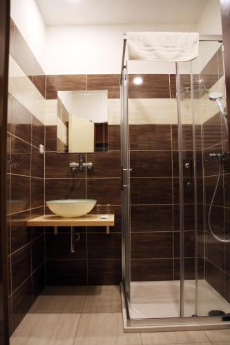 a bathroom with a sink and a shower at Penzion Alfa Poděbrady in Poděbrady