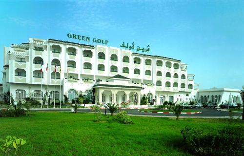 a white building with a green out sign on it at Hôtel Green Golf Hammamet in Hammamet