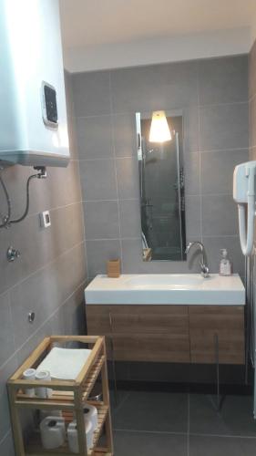 a bathroom with a tub and a sink and a mirror at Apartmani Luce in Zadar