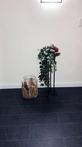 a pair of shoes and a table with flowers at Glockenstuhl @Conny's in Brilon
