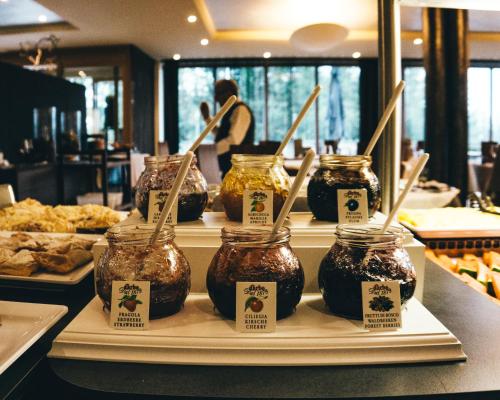 a display of jars of food on a counter in a restaurant at Josef Mountain Resort in Avelengo
