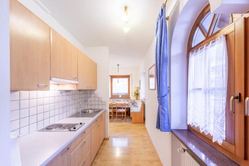 eine Küche mit einem Waschbecken und einem Fenster in der Unterkunft Seaberhof in Kaltern
