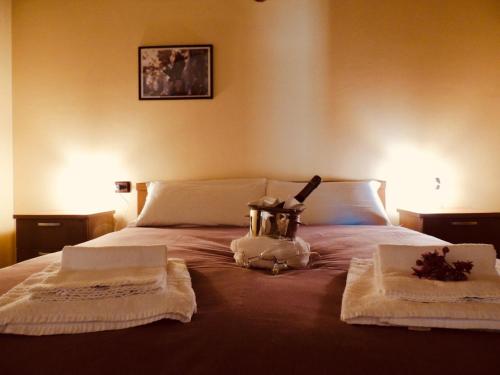 a bed with two towels and a bottle on it at Ostello Brembo in Camerata Cornello