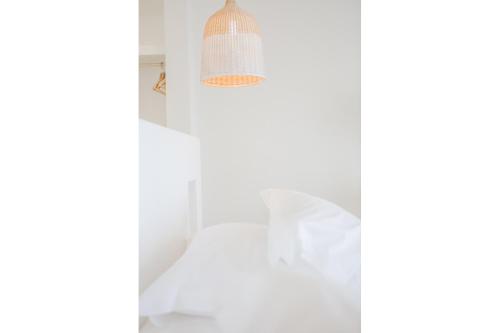 a light fixture in a room with white walls at Agnandi Cielo in Tourlos
