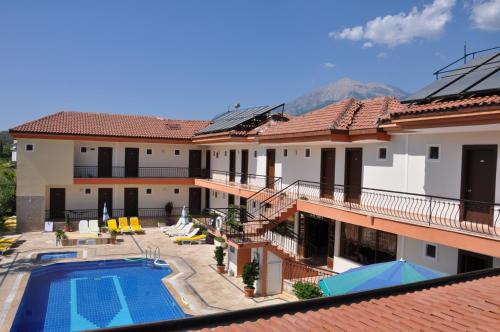 a view of a building with a swimming pool at MG Moms Hotel in Kemer