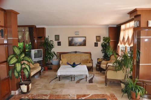a living room with a couch and a table at MG Moms Hotel in Kemer