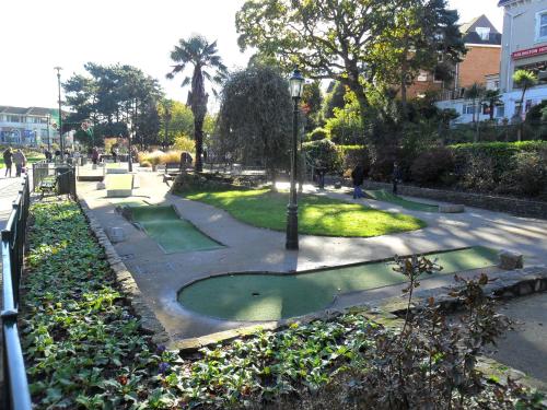 a park with green grass and a street light at Cecil Court Hotel in Bournemouth