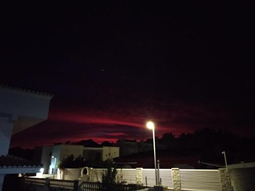 a dark sky with a street light in front of a building at GOLDEN TOWER pensión Auto Check-in in Gandía
