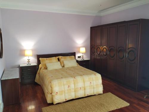 a bedroom with a large bed and two night stands at El olivo in Tordesillas