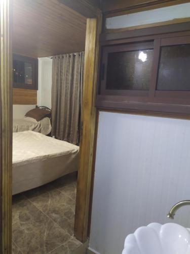 a small bedroom with a bed and a window at Success Hostel in Nablus
