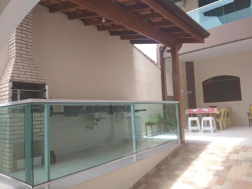 a glass aquarium in a house with a fireplace at Lar da Erica in Ubatuba