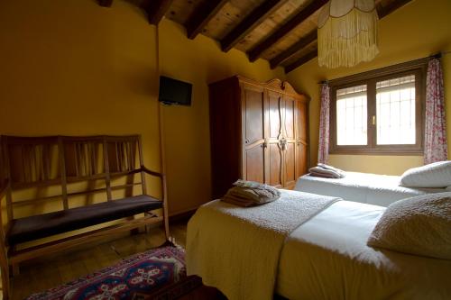 a bedroom with two beds and a window at Riojania in Munilla