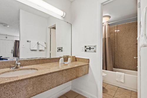 a bathroom with a sink and a toilet at Economy Lodge Portsmouth in Portsmouth