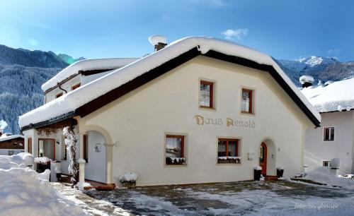 a building with snow on top of it at Haus Arnold - Privatzimmer und Ferienwohnungen in Sillian