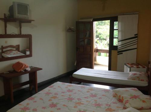 מיטה או מיטות בחדר ב-Pousada Vila Verde