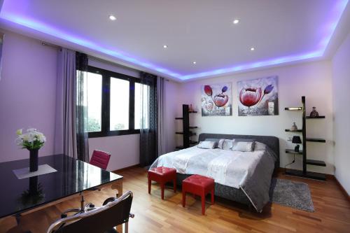 1 dormitorio con 1 cama y 1 mesa con sillas rojas en DREAM VILLA IN ALBIR BLUELINE, en L'Alfas del Pi
