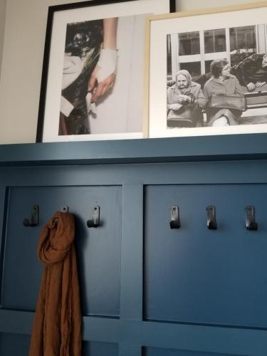 a blue dresser with pictures on top of it at Redford Hotel in New York