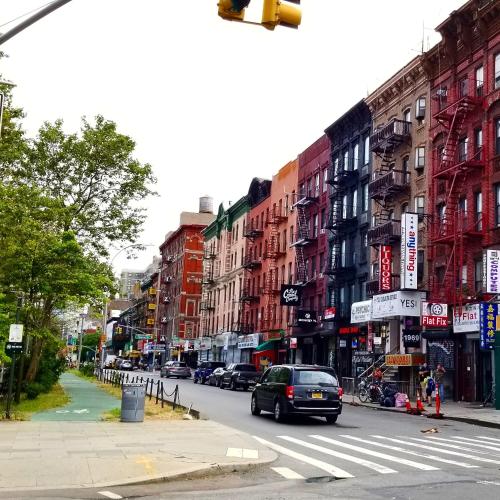 a busy city street with a traffic light and buildings at Redford Hotel in New York