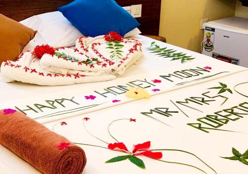 a bed with a cake on it with the words happy new year at Detour Beach View in Hangnaameedhoo