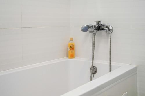 a shower in a bathroom with a white tub at Cozy apartment in a new building close to the downtown in Kyiv