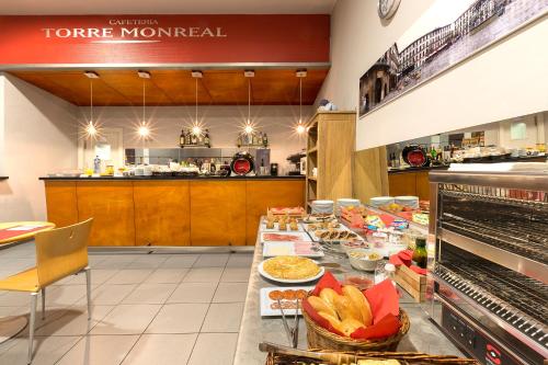 a kitchen with a long table with food on it at Hotel Torre Monreal in Tudela