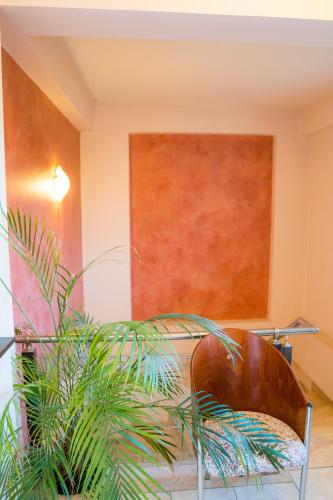 a living room with a chair and a wall at Yiannis Apartments in Ioannina