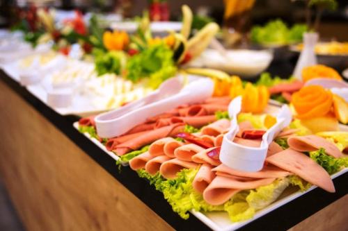 a buffet with a variety of meats and vegetables at Hira Hotel in Istanbul