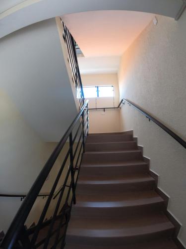 a staircase in a building with a stair railing at Morada da Marta in Guarda do Embaú
