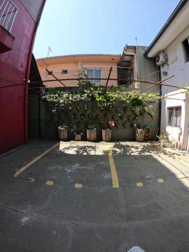 a parking lot with potted plants next to a building at Morada da Marta in Guarda do Embaú