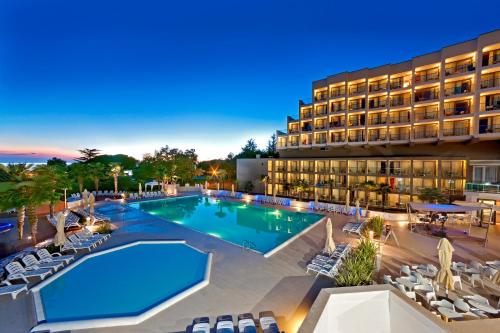 an image of a resort pool at night at Hotel Materada Plava Laguna in Poreč