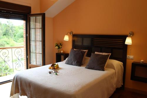 a bedroom with a bed with a teddy bear on it at Apartamentos rurales la Aguilera in Oviñana