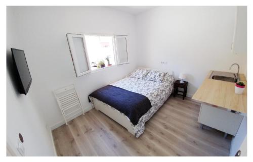 a small bedroom with a bed and a window at Casa Lagunera in Las Lagunas