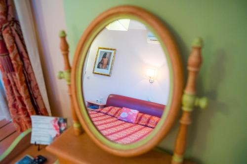 a mirror on a dresser in a bedroom at Yiannis Apartments in Ioannina