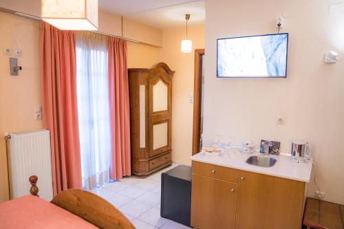 a bathroom with a sink and a mirror on the wall at Yiannis Apartments in Ioannina