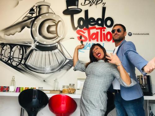 a man and a woman standing in a room with a blender at ToledoStation B&B in Naples