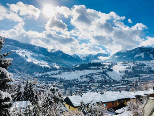 a view of a town in the mountains with snow at Winzig Apartment in Schladming