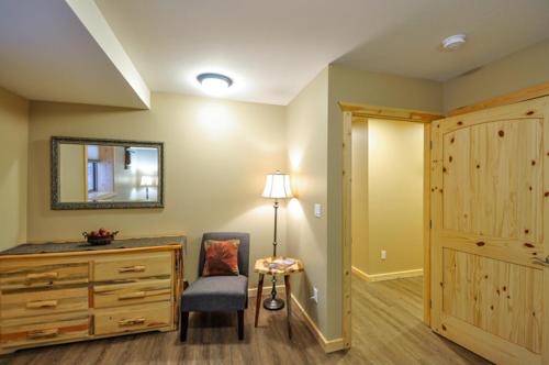 a room with a dresser and a chair and a mirror at Paddle Ridge in West Glacier