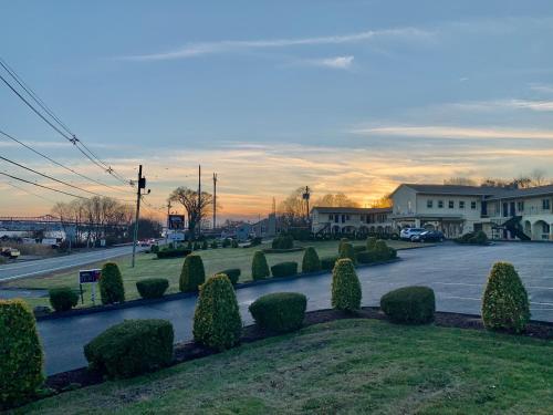 a view of a parking lot with bushes and a street at Orbits Inn in Somerset