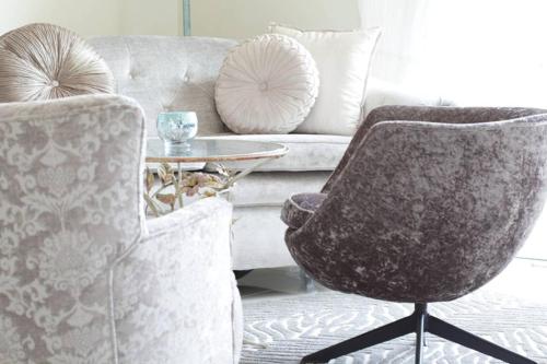 a living room with a couch and a chair at L`Azur : Elegant Apartment with Sea View in Wilderness
