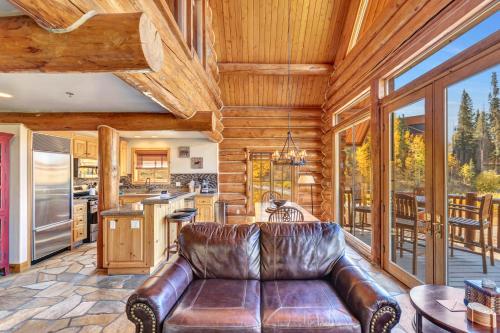 a leather couch in a living room with a kitchen at Mountain Lodge at Telluride in Telluride