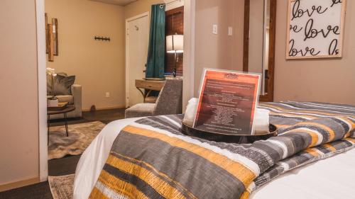 a hotel room with a bed with a sign on it at Playpark Lodge in South Lake Tahoe