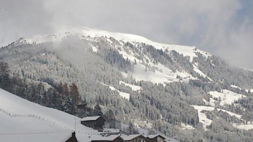 a mountain covered in snow with a ski slope at Hotel Sportalm in Gerlos