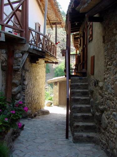 a stone alley with stairs leading to a building at The Mill Hotel in Kakopetria