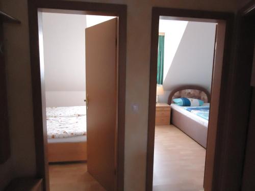 an open door to a bedroom with a bed at Pension an der Stadtmauer Apartments in Wernigerode