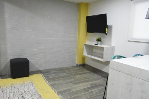 a living room with a tv on a wall at TJ Border Suites by Hosted by Me in Tijuana