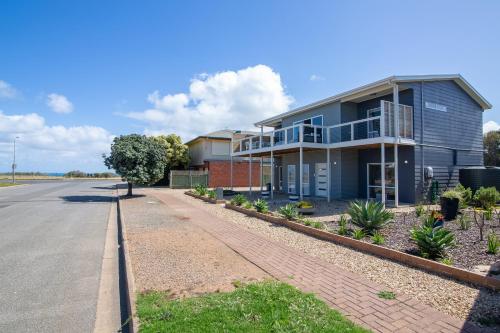 a blue house on the side of a road at Xanadu - Aldinga Beach - C21 SouthCoast Holidays in Aldinga Beach