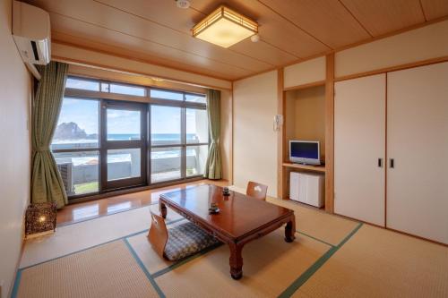 
a living room with a couch and a table at Hotel Sun Resort Shonai in Tsuruoka

